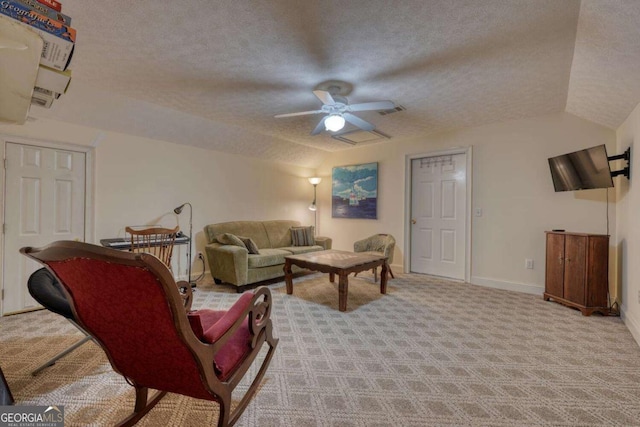 living room with carpet, a textured ceiling, ceiling fan, baseboards, and vaulted ceiling