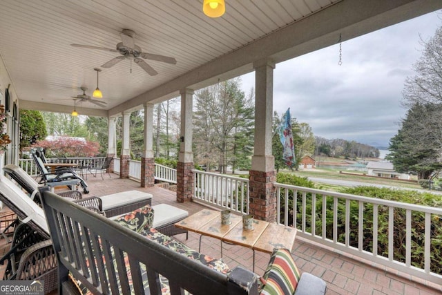 wooden deck with ceiling fan and covered porch