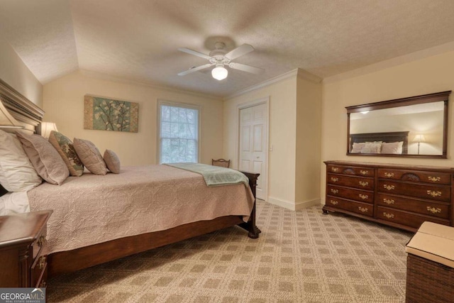 bedroom featuring light colored carpet, ceiling fan, baseboards, a textured ceiling, and crown molding