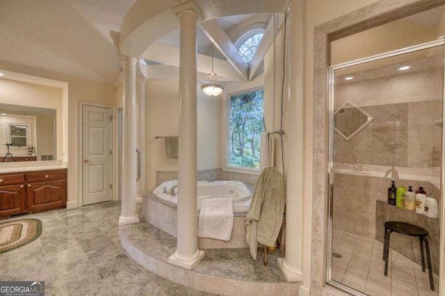 bathroom with ornate columns, a bath, a stall shower, vanity, and baseboards