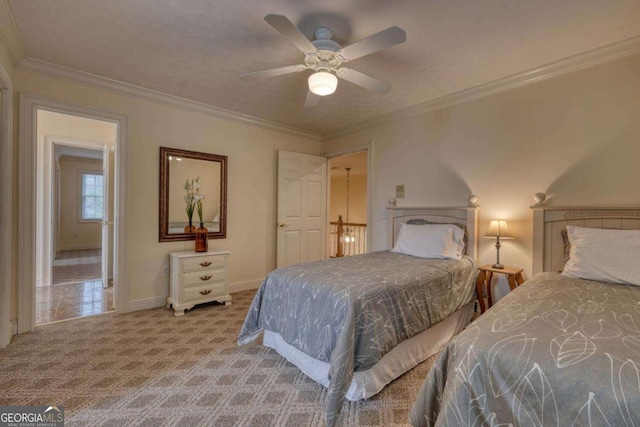 bedroom featuring ornamental molding, baseboards, carpet flooring, and a ceiling fan