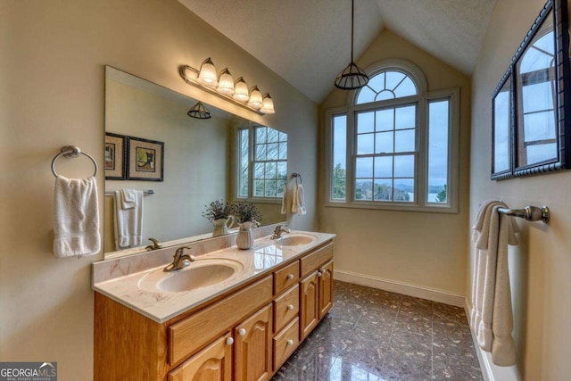full bathroom with vaulted ceiling, plenty of natural light, baseboards, and double vanity
