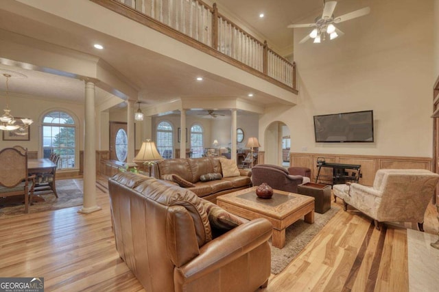 1891 Cedar Cliff Rd, Hiawassee, GA 30546 - living room featuring ceiling fan, ornate columns, crown molding, light wood-type flooring, and wainscoting