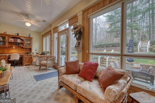 living area featuring a ceiling fan