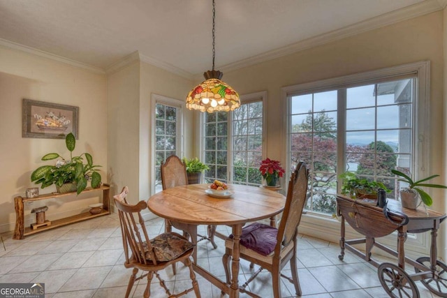 dining area with light tile patterned floors, ornamental molding, and baseboards