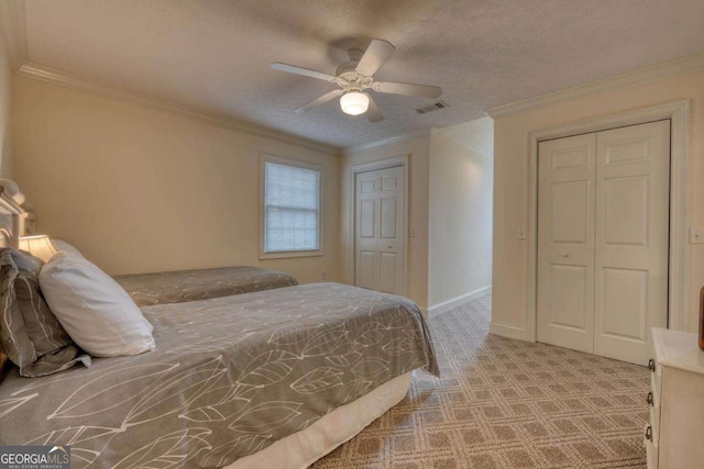 bedroom featuring carpet, ornamental molding, ceiling fan, baseboards, and multiple closets