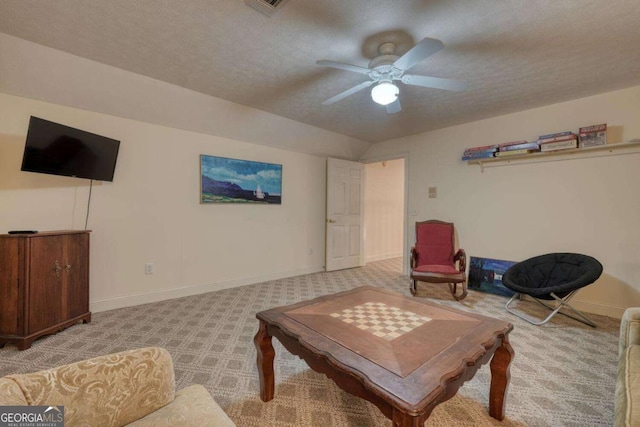 living room with light carpet, baseboards, ceiling fan, a textured ceiling, and vaulted ceiling