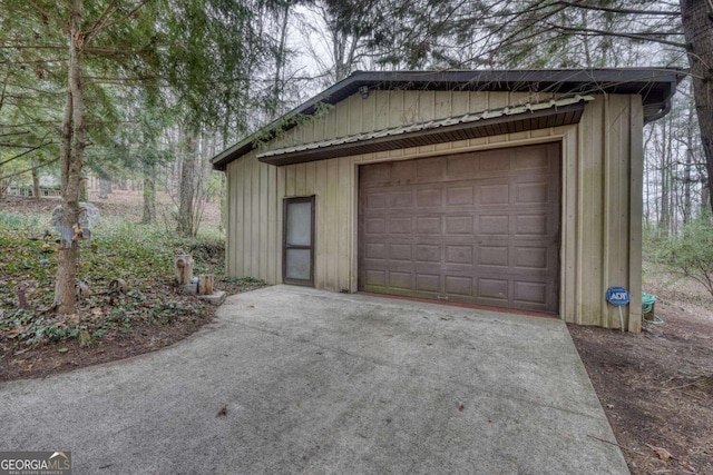 garage featuring concrete driveway