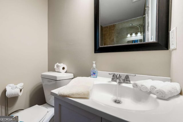 bathroom featuring toilet and vanity