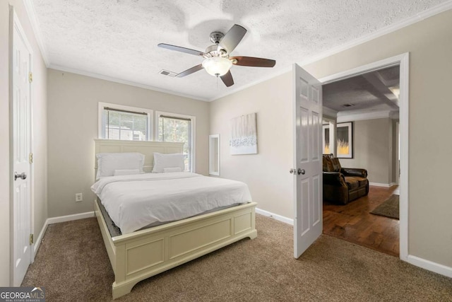 carpeted bedroom featuring crown molding, baseboards, a textured ceiling, and a ceiling fan