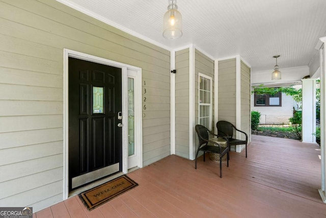 view of exterior entry with a porch