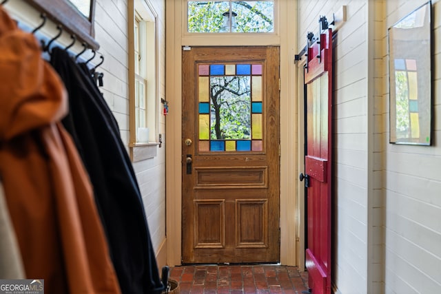 218 Barry St, Decatur, GA 30030 - foyer featuring plenty of natural light, wooden walls, and brick floor