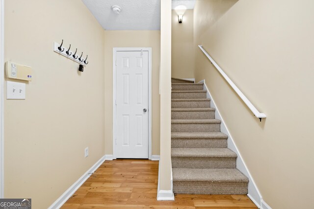5213 Pinnacle Point Cts, Norcross, GA 30071 - stairs featuring baseboards and wood finished floors