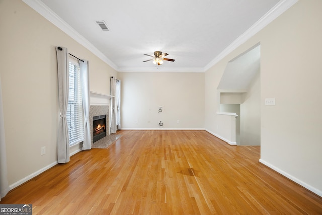 5213 Pinnacle Point Cts, Norcross, GA 30071 - unfurnished living room with visible vents, a tiled fireplace, a ceiling fan, crown molding, and light wood finished floors