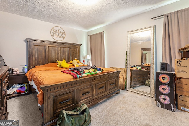 bedroom with light carpet and a textured ceiling