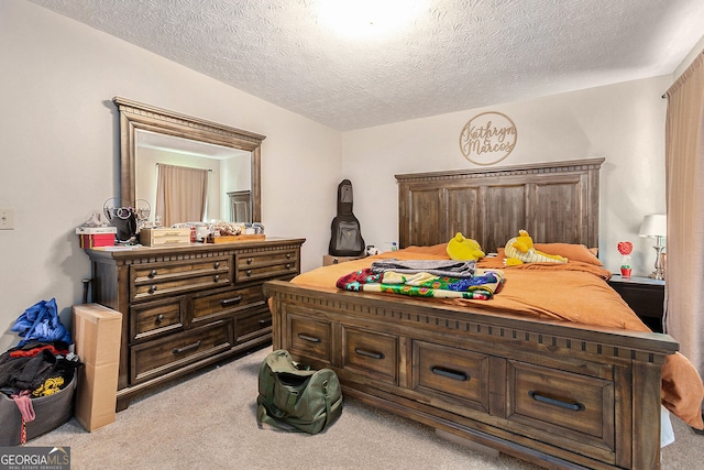 bedroom featuring a textured ceiling and light colored carpet