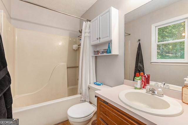 bathroom featuring toilet, a textured ceiling, vanity, and shower / bath combo