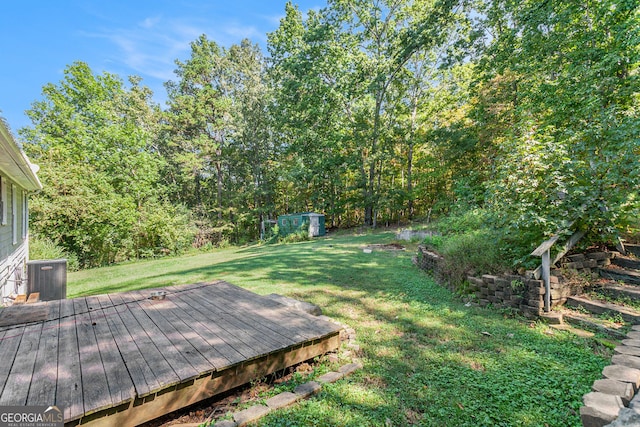view of yard with a deck and central AC