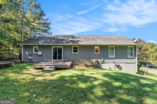 back of house with a yard, fence, and a wooden deck
