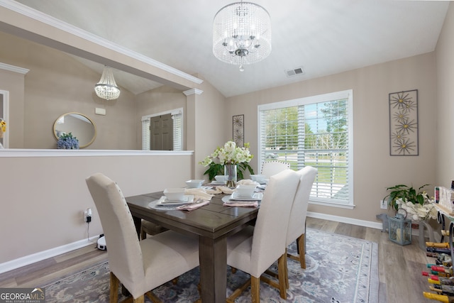101 Javay Ct, Villa Rica, GA 30180 - dining space with a chandelier, wood finished floors, and lofted ceiling