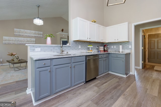 101 Javay Ct, Villa Rica, GA 30180 - kitchen with dishwasher, decorative backsplash, white cabinetry, light wood-style flooring, and high vaulted ceiling