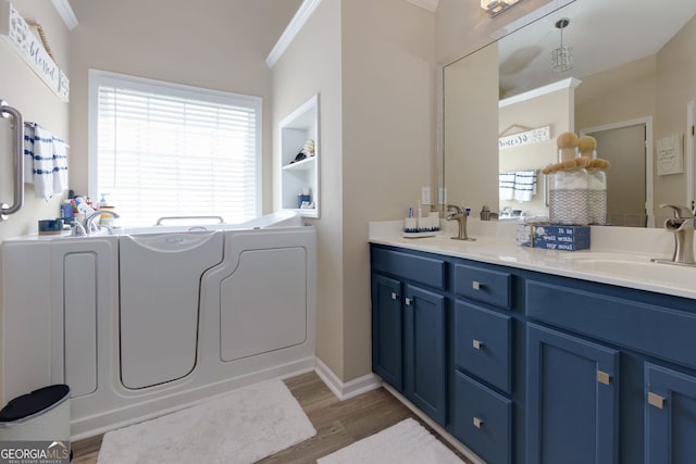 101 Javay Ct, Villa Rica, GA 30180 - full bathroom with ornamental molding, wood finished floors, a garden tub, and double vanity