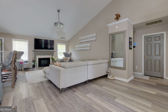 101 Javay Ct, Villa Rica, GA 30180 - living area with light wood-style floors, high vaulted ceiling, and a tile fireplace