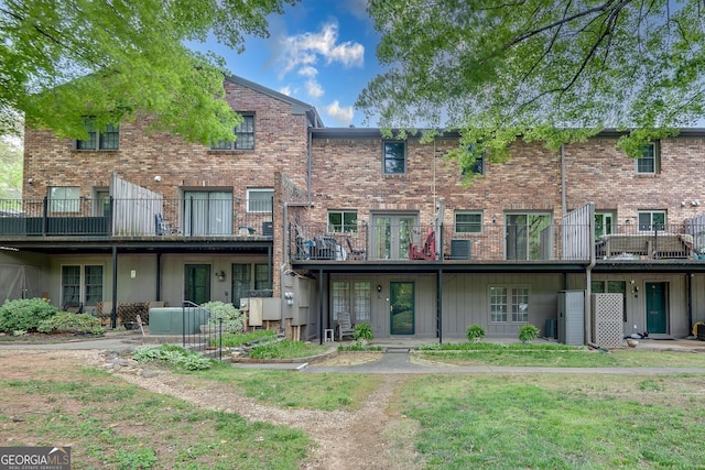 back of property featuring brick siding and central air condition unit