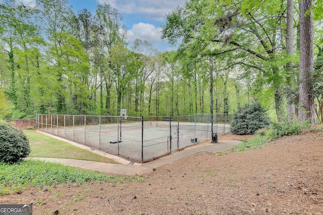 view of tennis court featuring fence
