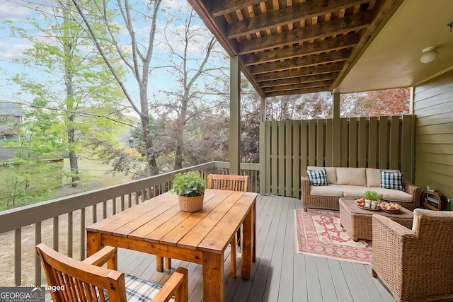 wooden terrace featuring outdoor dining area and an outdoor hangout area