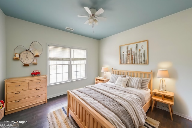 bedroom featuring ceiling fan, baseboards, dark wood finished floors, and visible vents