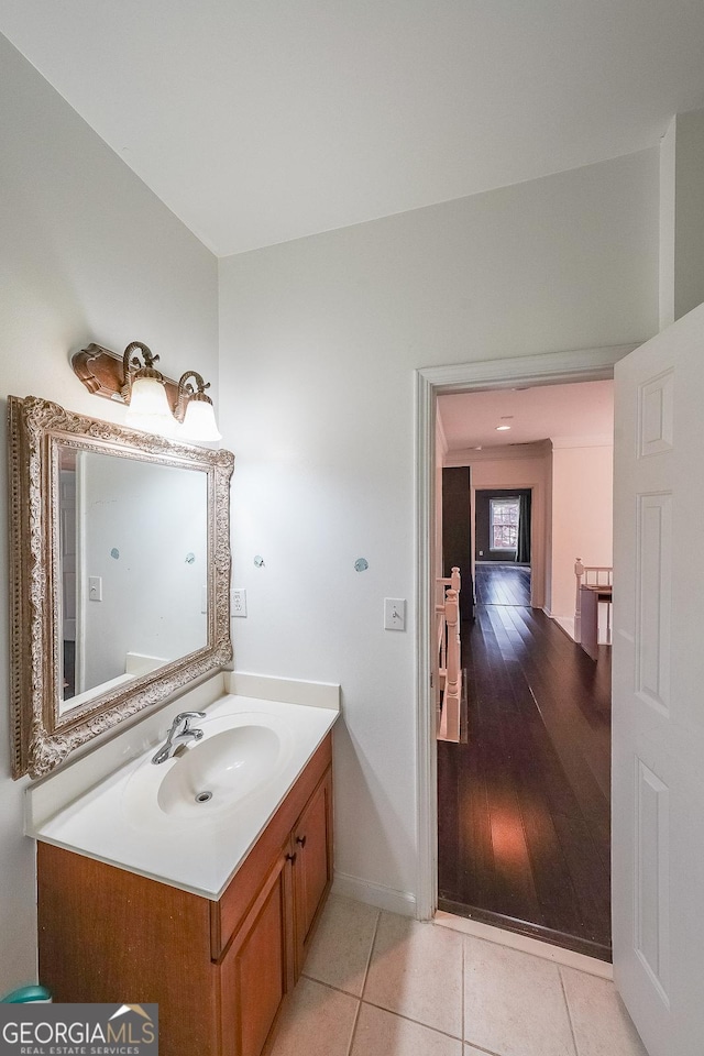 bathroom with tile patterned floors, vanity, and baseboards
