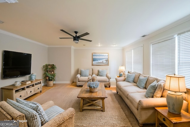 living room featuring visible vents, baseboards, ceiling fan, light wood-type flooring, and crown molding