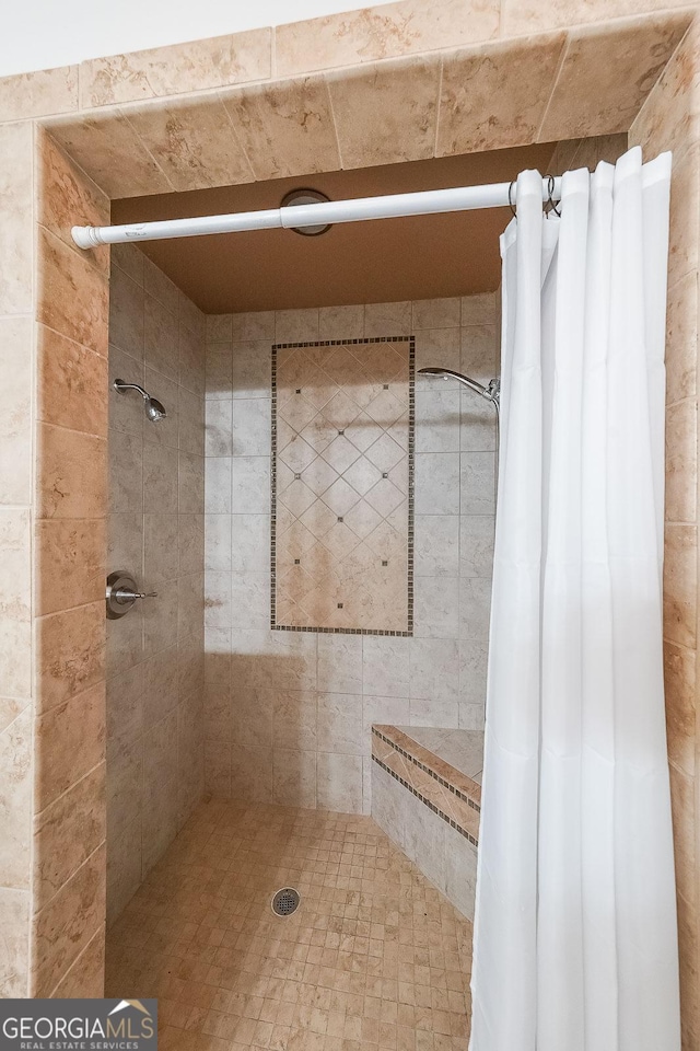 bathroom with a tile shower