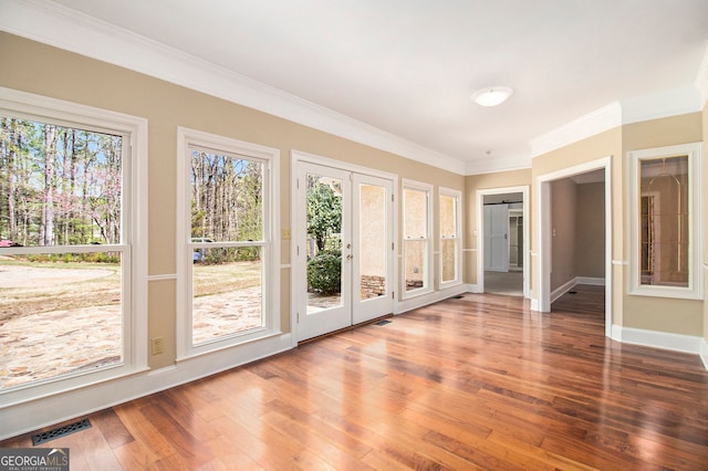 doorway to outside featuring ornamental molding, hardwood / wood-style flooring, baseboards, and french doors