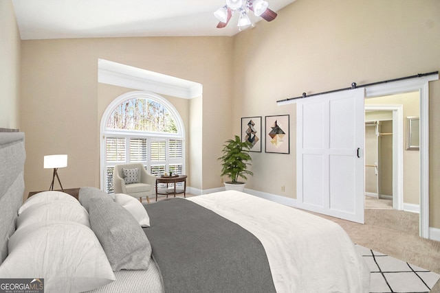 bedroom with high vaulted ceiling, a barn door, carpet flooring, a spacious closet, and ceiling fan
