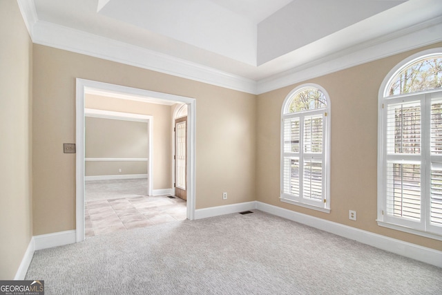 carpeted spare room with ornamental molding and baseboards