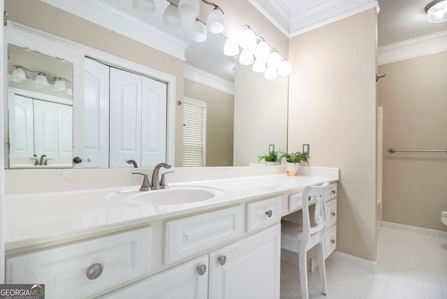 bathroom featuring crown molding, vanity, toilet, tile patterned floors, and baseboards