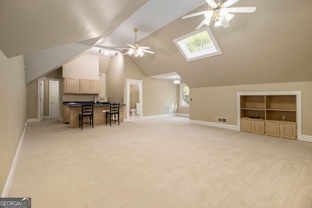bonus room with ceiling fan, light colored carpet, baseboards, and vaulted ceiling