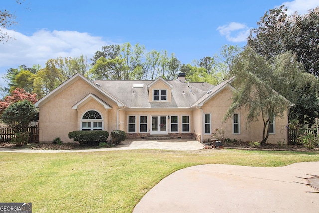 back of house featuring a patio, a chimney, and stucco siding