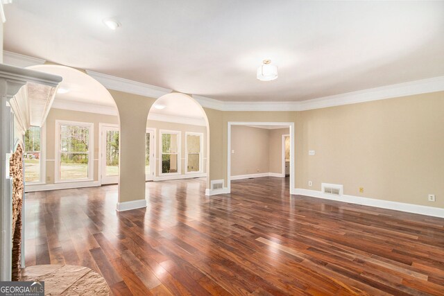 110 Kylemore Pass, Tyrone, GA 30290 - unfurnished room with dark wood finished floors, crown molding, baseboards, and arched walkways