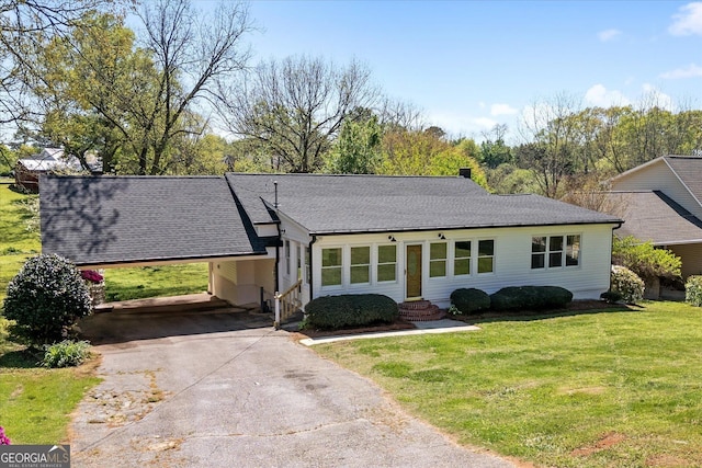 ranch-style house featuring aphalt driveway, entry steps, a front yard, a shingled roof, and an attached carport