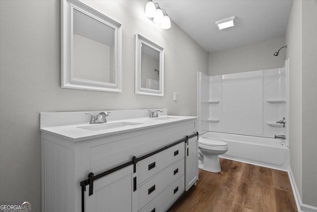 313 Ellenwood Dr, Bowdon, GA 30108 - full bathroom featuring wood finished floors, double vanity, toilet, and shower / bath combination