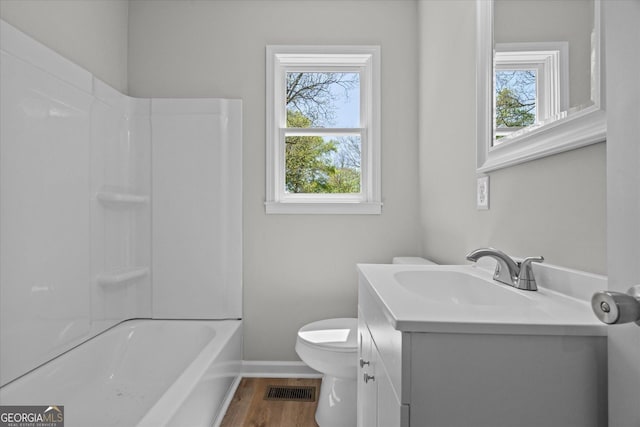 full bath with visible vents, baseboards, toilet, vanity, and wood finished floors