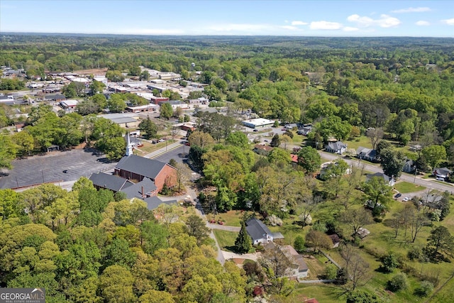 aerial view featuring a wooded view and a residential view
