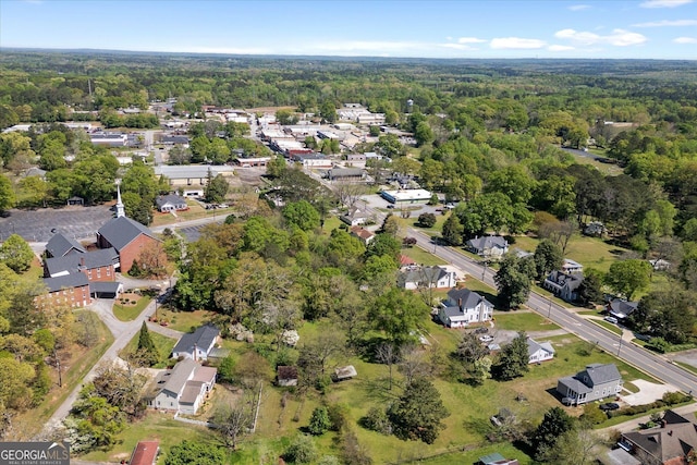 aerial view featuring a view of trees and a residential view