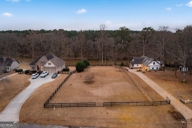 birds eye view of property with a rural view and a view of trees