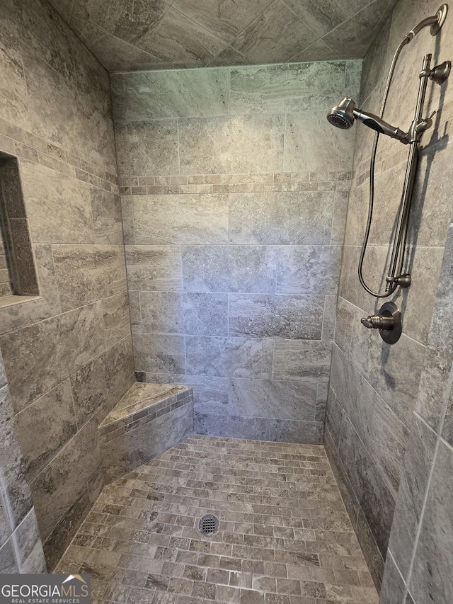 bathroom with a tile shower
