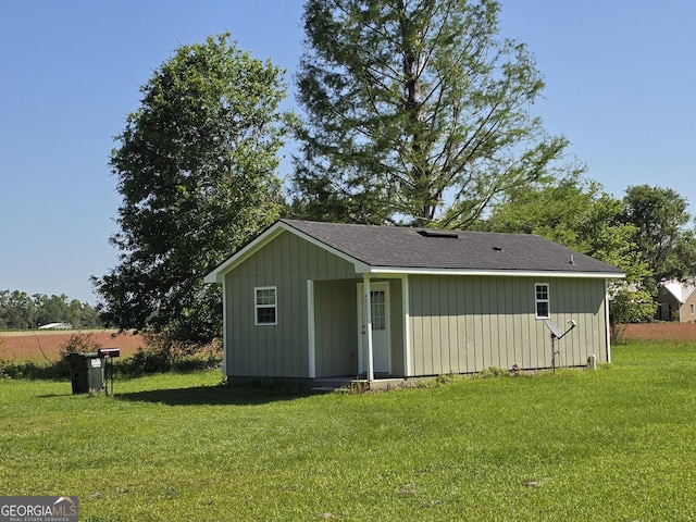 back of property with a lawn