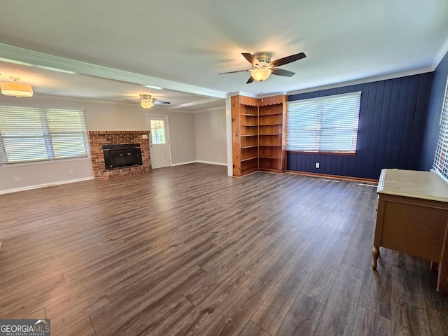 unfurnished living room featuring dark wood-type flooring, ceiling fan, baseboards, and a fireplace